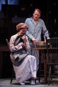 Annie Fitzpatrick as Linda Loman cradles her husband Willy's coat, as son Hap, played by Jared Joplin, looks on