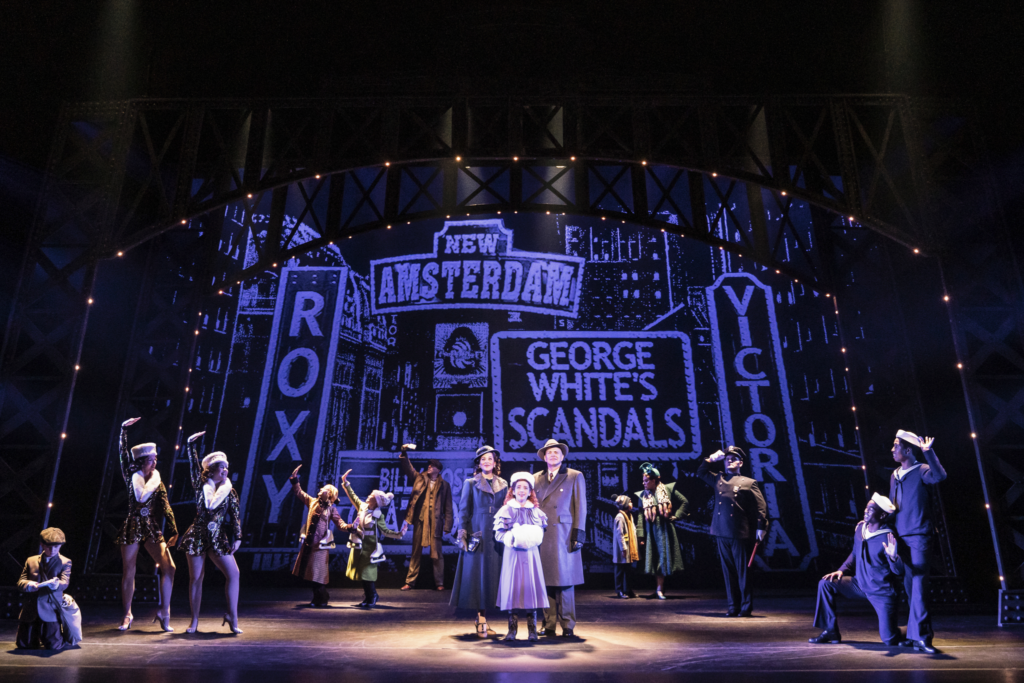 The 2022 company of ANNIE, in front of "Broadway."