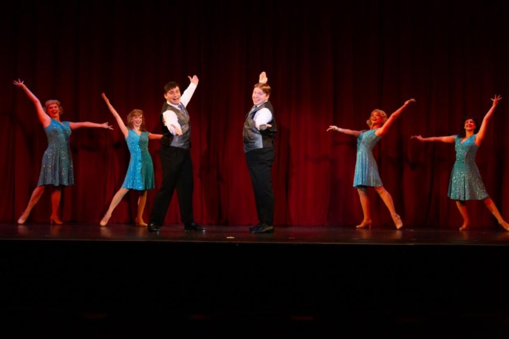 Cast of "Irving Berlin's Holiday Inn The Musical" at Covedale Center for Performing Arts Posing at the end of a dance number onstage